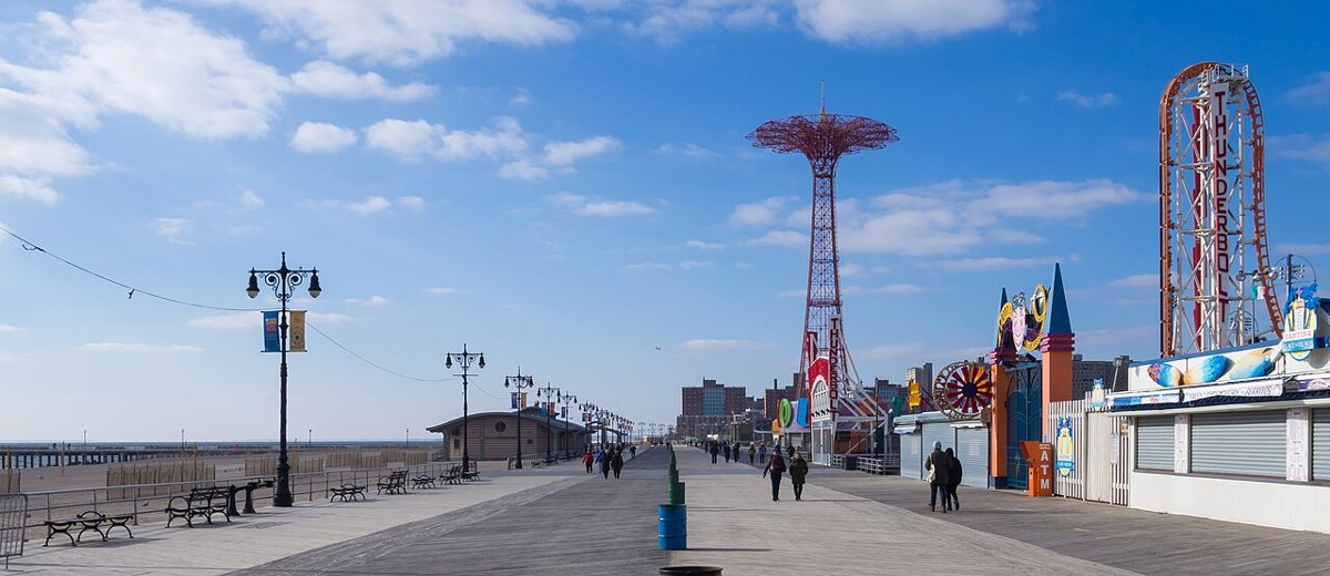 the boardwalk and amusement rides at Coney Island in spring