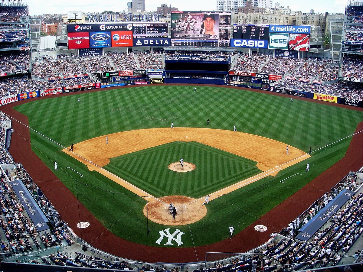 Yankee Stadium exterior with the Great Hall entrance and New York skyline visible on a game day