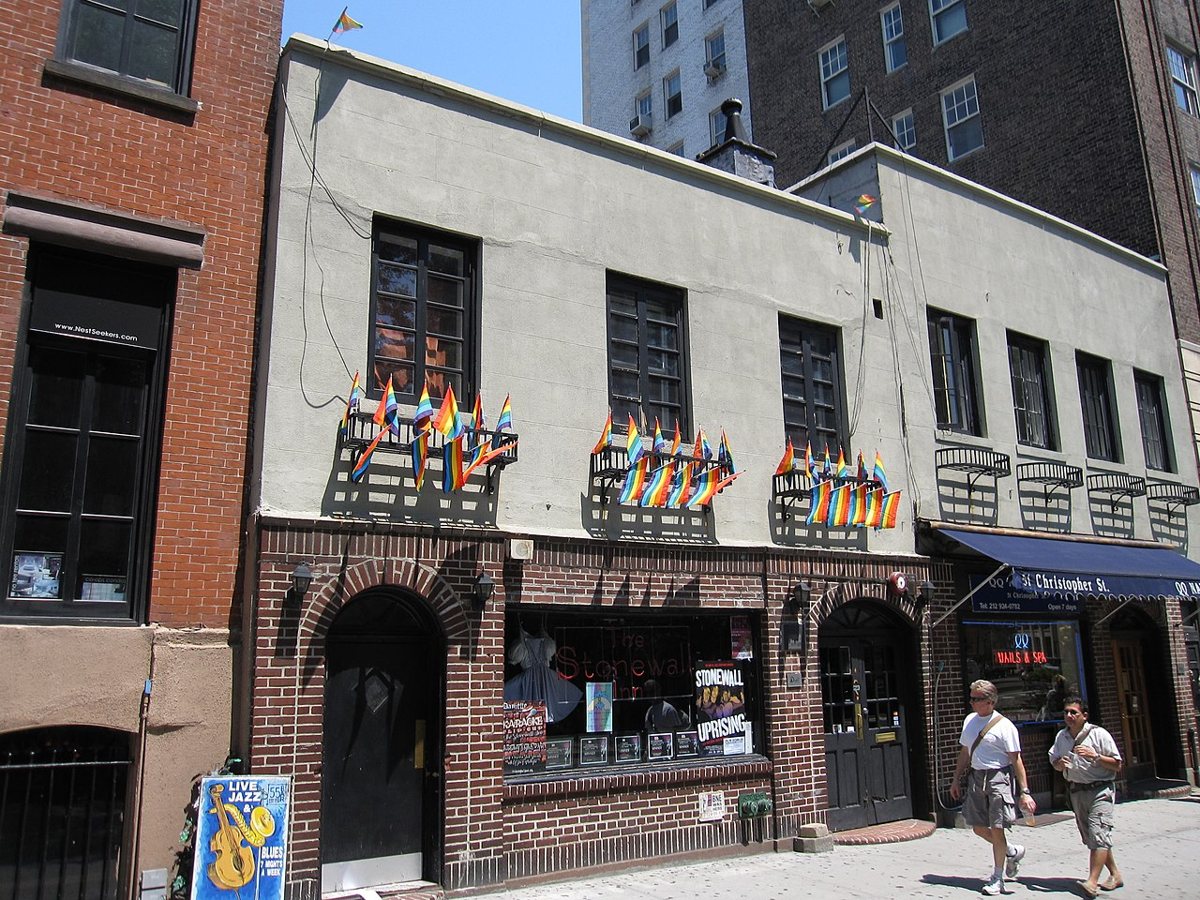 the Stonewall Inn storefront with rainbow flags on Christopher Street