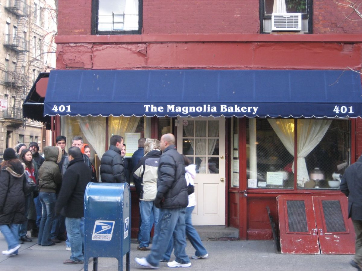 the exterior of Magnolia Bakery with its awning on Bleecker Street